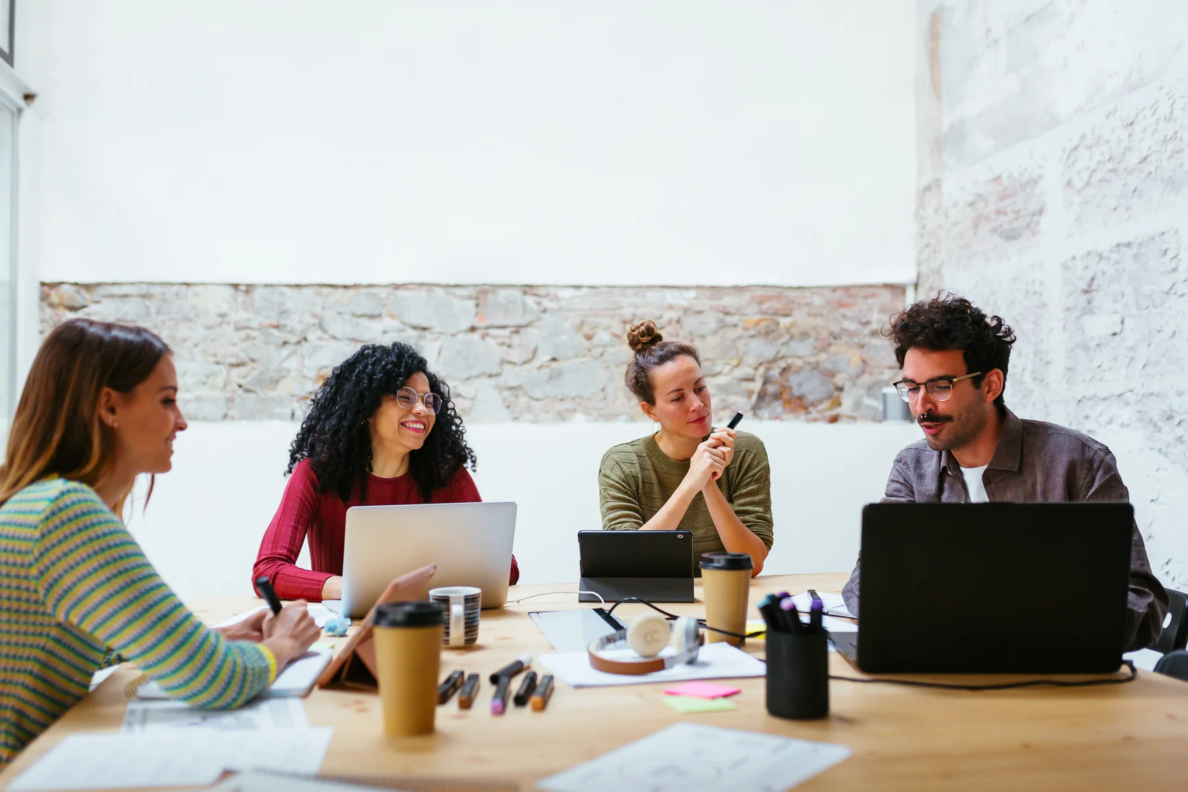 Young-team-working-together-in-a-meeting-room Young team working together in a meeting room